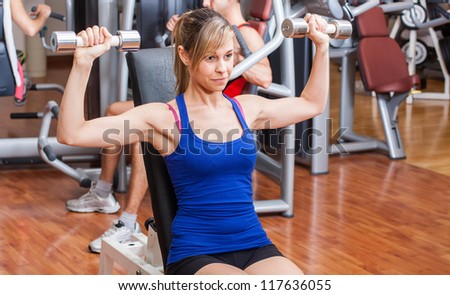Beautiful woman working out in a fitness club