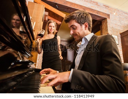 Man playing piano for his girlfriend