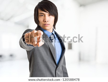Chinese man pointing at camera