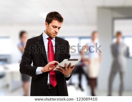 Businessman Using His Tablet In The Office