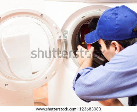 Technician repairing a washing machine
