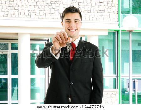 Portrait of an agent giving you the keys of your new property