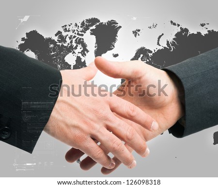 Businessmen shaking hands against an hi-tech background