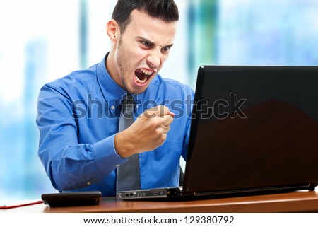 Angry businessman against his computer