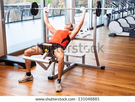 Man training on a bench in a fitness club