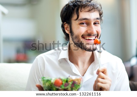 Young man eating a healthy salad
