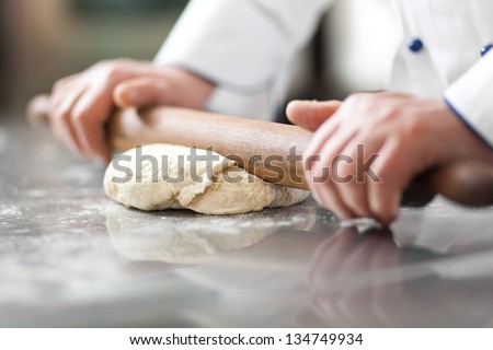 Chef Preparing Dough In A Kitchen