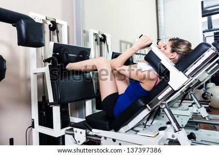 Woman using a leg press machine in a fitness club