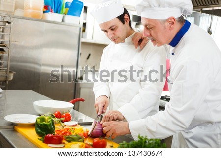 Friendly chef preparing vegetables in his kitchen