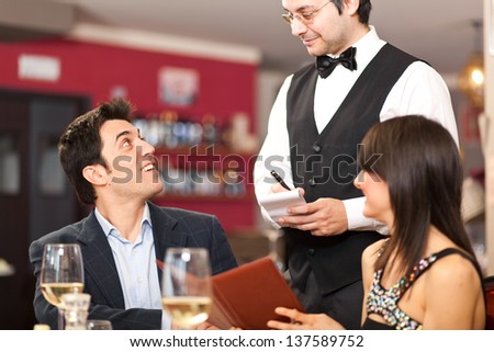 Waiter taking orders in a restaurant