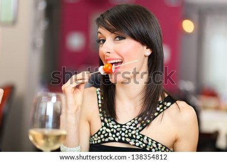 Beautiful woman eating at the restaurant