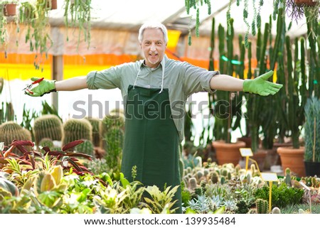 Happy gardener in a greenhouse