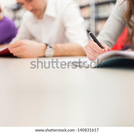 Group Of Students Doing A Research In A Library