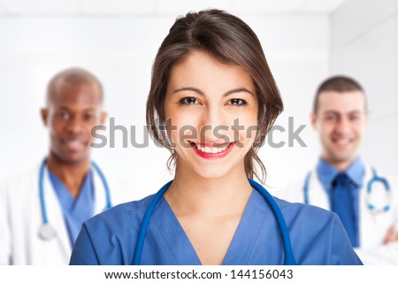 Young smiling doctor in front of her team