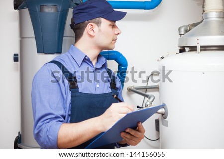Technician Servicing An Hot-Water Heater