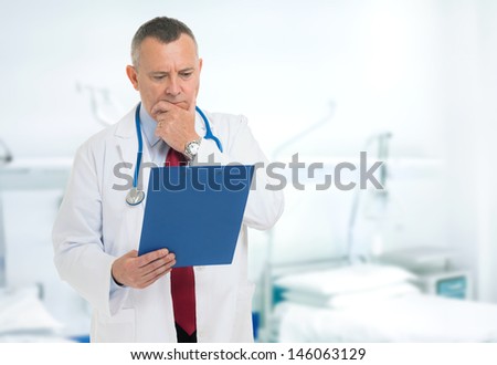 Doctor reading a case history