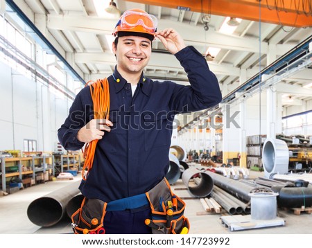 Portrait of an happy worker in a factory