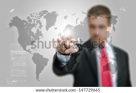 Businessman pointing his finger on a hi-tech world map