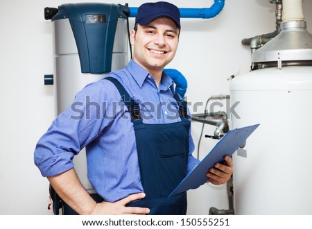 Smiling technician servicing an hot-water heater
