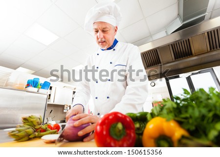 Senior chef preparing vegetables