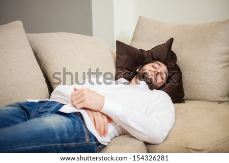 Handsome man sleeping on his couch