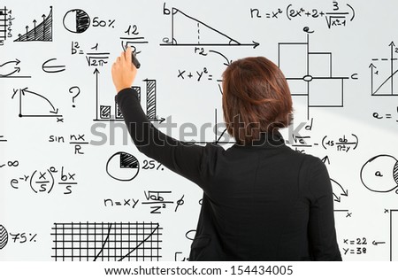 Woman writing formulas on a white board
