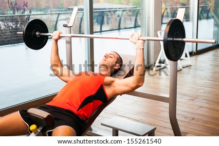 Man training on a bench in a fitness club