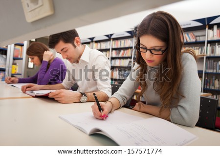 Group of students doing a research in a library