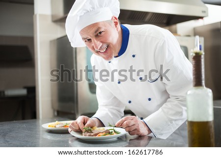 Professional chef garnishing a dish