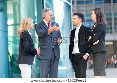 Group of business people talking outdoor in an urban setting
