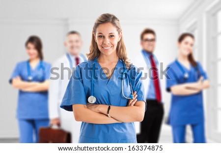 Portrait Of A Nurse In Front Of Her Medical Team