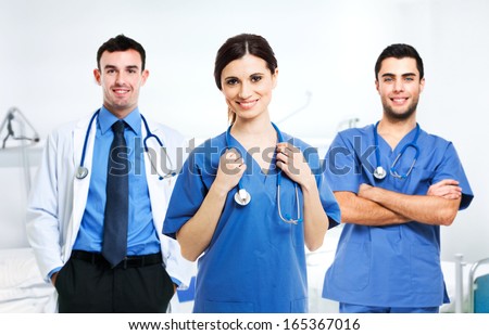 Portrait Of A Smiling Nurse In Front Of Her Medical Team