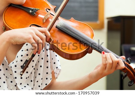 Woman learning to play violin