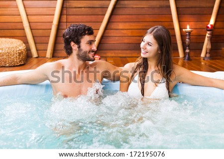 Happy Couple Relaxing In A Hot Tub