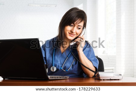 Portrait of a beautiful smiling nurse talking on the phone