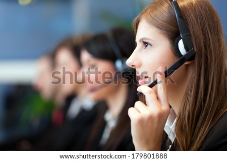 Busy call center operators in a modern office