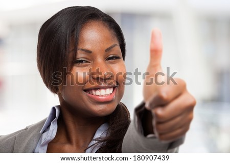Very happy young woman giving thumbs up