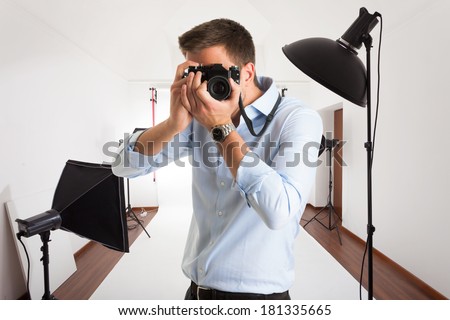 Photographer at work in his photographic studio
