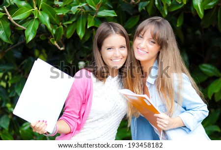 Two female student friends smiling outdoor