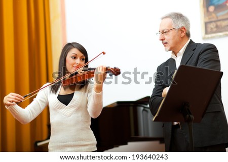 Violin teacher helping a student at the conservatory
