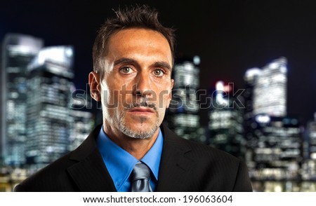 Mature businessman in the city at late night