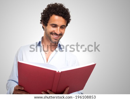 Smiling man reading a book