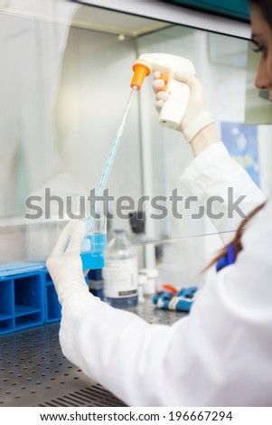 Scientist working in a microbiological safety cabinet