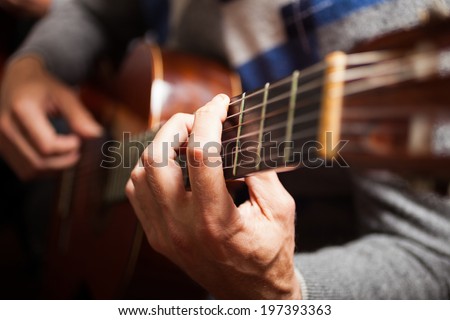 Detail of a guitarist playing a classical guitar