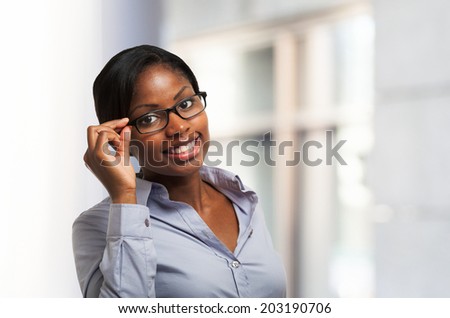 Young smiling black woman holding her eyeglasses