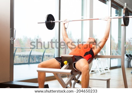 Man lifting a yoke in a fitness club