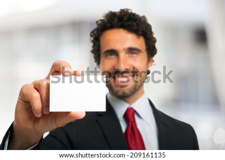 Smiling businessman showing an empty business card