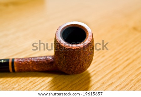 Smoke pipe on a wooden table