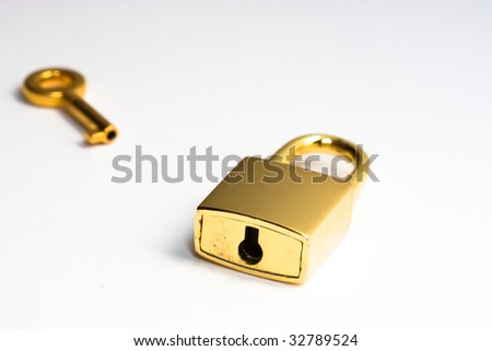 Golden key near a lock