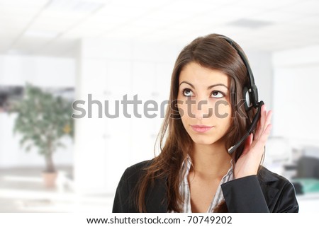 Female secretary speaking over the headset in an office environment